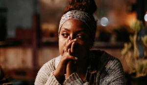 a woman thinks deeply and is reflecting on the past year