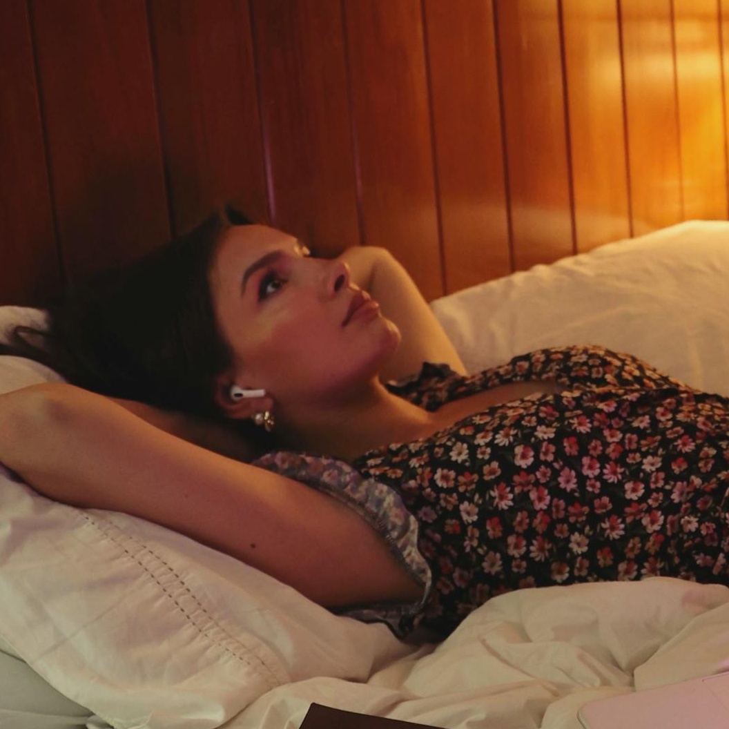 a women overthinking everything in life while lying in bed