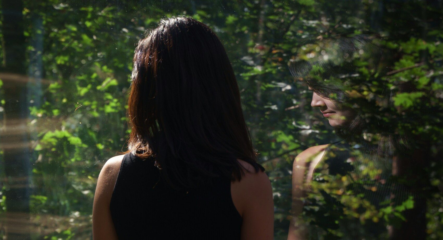 reflection of a woman in the mirror, she's ruminating about life